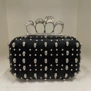 New knuckle clutch with all over skull studs